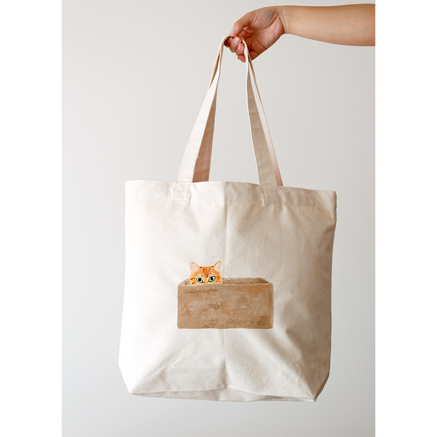 Orange Tabby Cat in a cardboard box paint-painted on a natural beige tote bag