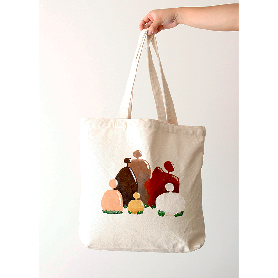 Hand-painted beige rocks depicting people on a cotton natural beige canvas bag