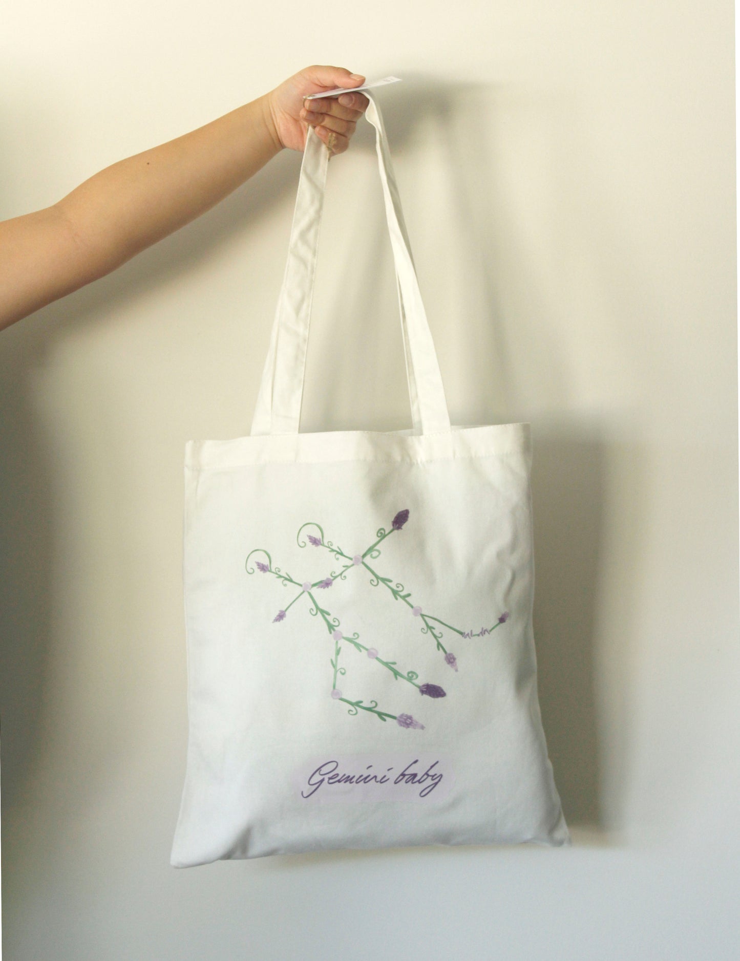 White tote bag with a Gemini Astrology constellation against a white background