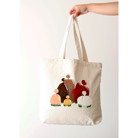 Hand-painted beige rocks depicting people on a cotton natural beige canvas bag
