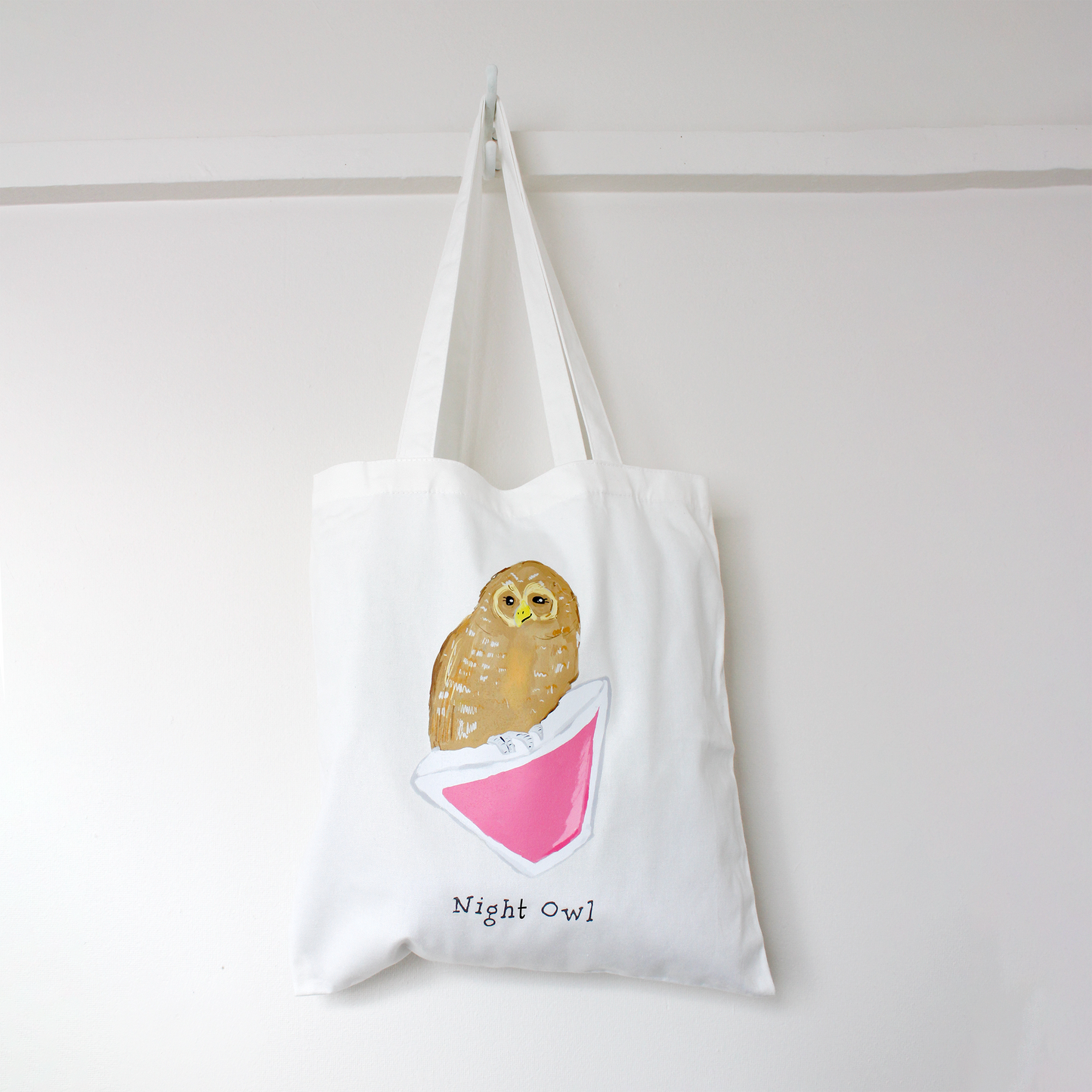 White tote bag with an owl design and 'Night Owl' text on a white background