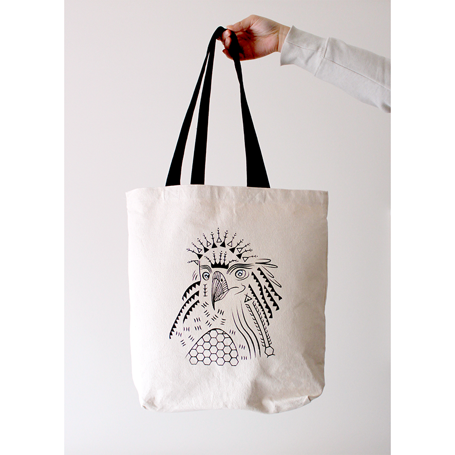Hand-painted tote bag with a design of a Philippine eagle and tribal patterns in black on a white background.